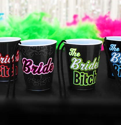 These plastic shot glasses are a fun party favor for a Bachelorette Party and help identify the bride. The set includes one "Bride" and 5 "Bride's Bitch" shot glass necklaces. 