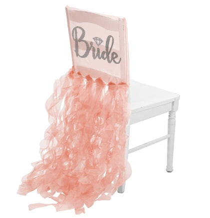 The bride will be the center of attention with this fun sheer white chair cover! Made of sheer organza, rhinestones spell out BRIDE in a pretty cursive font accented with a silver glitter diamond icon!