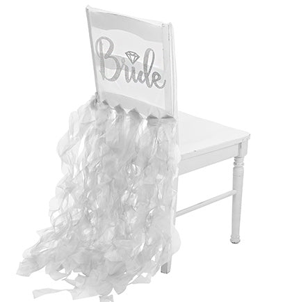 The bride will be the center of attention with this fun sheer white chair cover! Made of sheer organza, rhinestones spell out BRIDE in a pretty cursive font accented with a silver glitter diamond icon!