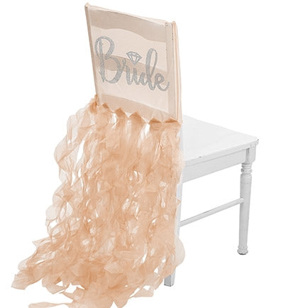 The bride will be the center of attention with this fun sheer gold chair cover! Made of sheer organza, rhinestones spell out BRIDE in a pretty cursive font accented with a silver glitter diamond icon!