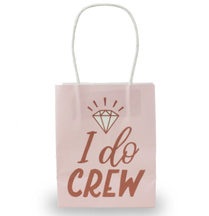 A pink bag with white handles that say I Do Crew in metallic rose gold.  This 4.5" mini gift bag is perfect to hand out with goodies or favors.