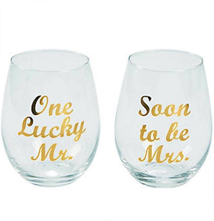 Celebrate your upcoming marriage with these perfect stemless wine glasses! The pair of glasses say "One Lucky Mr." and "Soon To Be Mrs." in a metallic gold foil. They are perfect as a engagement gift or favor for wine lovers.