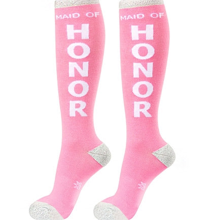These fun knee-high bachelorette party socks are perfect for the maid of honor! The socks say MAID OF HONOR in white lettering with metallic silver trim.