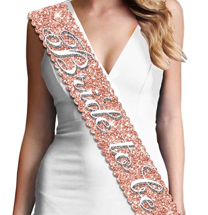 Show off at the bridal shower or bachelorette party with this scalloped edge sparkly BRIDE TO BE sash! The perfect keepsake to put in a memento box. Made with a sparkle fabric that is smooth satin on the backside for a comfortable fit. The sparkle on this sash doesn't shed!