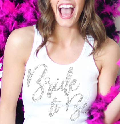 Have the bride stand out with this fabulous tank top. This ribbed tank says Bride to Be in bold glam font with real rhinestones. Get this for the bride to wear at her bridal shower, bachelorette party or any wedding event.