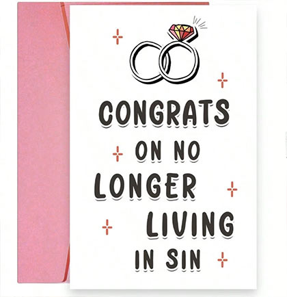 Card with wedding rings and text 'Congrats on no longer living in sin' on a white background with pink envelope and flowers.