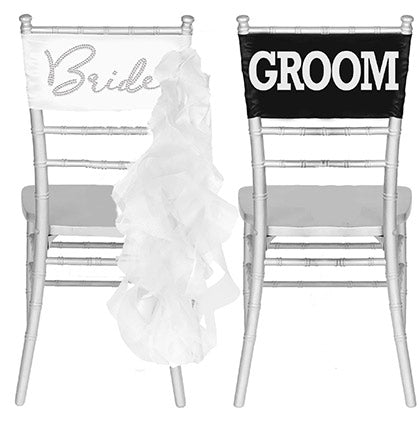 Two chair bands. Crystal rhinestone Bride on a white band with ruffles. White Groom on a black band. 