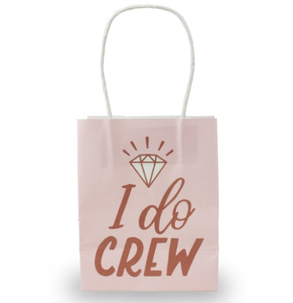 A pink bag with white handles that say I Do Crew in metallic rose gold.  This 4.5" mini gift bag is perfect to hand out with goodies or favors. 