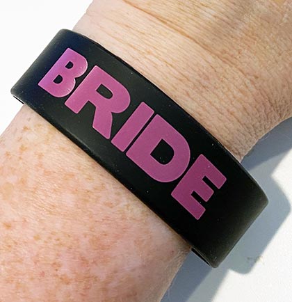 This Bride bracelet is perfect for the bride to wear during the bachelorette party. The rubber bracelet is black and pink and one size fits most. An easy and inexpensive party favor for the bride.  