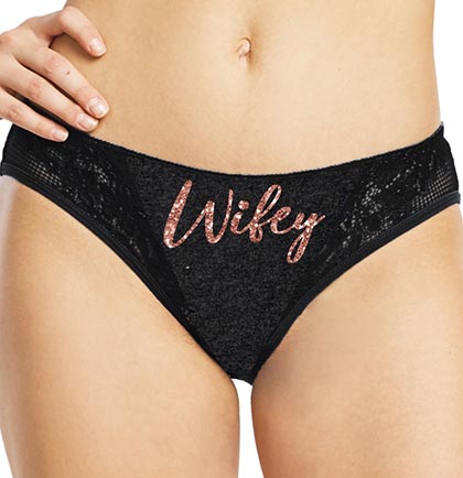 Give the bride these sexy thong panties at the bachelorette party or lingerie shower. The lace trimmed thong panties say Wifey in a pretty rose gold glitter on the front. She&#39;ll love to show off for her new spouse! 