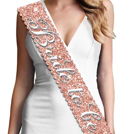 Show off at the bridal shower or bachelorette party with this scalloped edge sparkly BRIDE TO BE sash! The perfect keepsake to put in a memento box. Made with a sparkle fabric that is smooth satin on the backside for a comfortable fit. The sparkle on this sash doesn&#39;t shed!