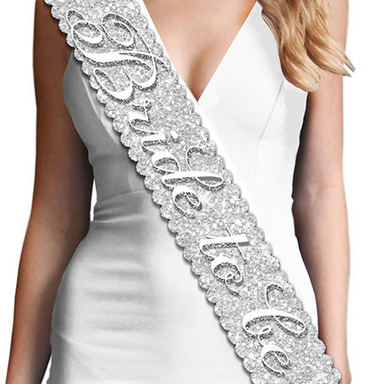 This sparkle sash is a stunning way for the Bride to stand out in the crowd! The scalloped edge sash says "Bride to Be" in white and silver gray. This sash is beautiful and unique and makes a great gift or accessory for a bridal shower or bachelorette party! Plus, the bride will love the matching Bridal Shower Sashes: Maid of Honor, Bridesmaid and Brides Entourage, available for purchase separately!