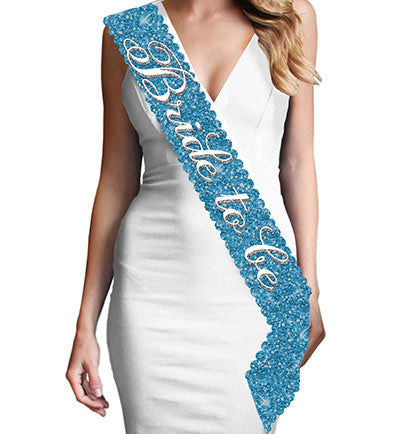 This gorgeous scalloped edge turquoise sparkle sash says "Bride to Be" in a pretty white and silver gray flirty font. This sash is beautiful, it won't shed sparkle and has a satin backside for a comfy fit.  Plus, this Bride to Be sash matches our other turquoise sparkle sashes: Maid of Honor, Bridesmaid &  Brides Entourage available for purchase separately!