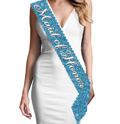Gift the main girl this gorgeous scalloped edge turquoise sparkle sash! The sash says "Maid of Honor" in a pretty white and silver gray flirty font. This sash is beautiful, it won't shed sparkle and has a satin backside for a comfy fit.  Plus, this Maid of Honor sash matches our other turquoise sparkle sashes: Bride to Be, Bridesmaid &  Brides Entourage available for purchase separately!