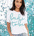 White jersey crew neck tshirt with an aqua glitter Bride To Be graphic on the front. 