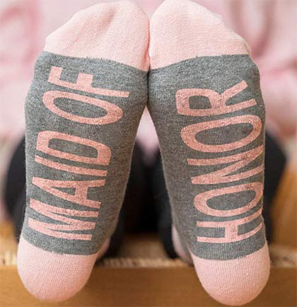 These trendy ankle socks say Maid of Honor on the bottom. The socks come in a pretty pink accented with grey. Wear a pair during the bachelorette party or the getting ready the day of the wedding!