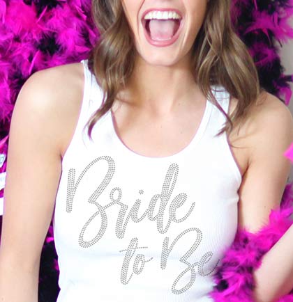 Have the bride stand out with this fabulous tank top. This ribbed tank says Bride to Be in bold glam font with real rhinestones. Get this for the bride to wear at her bridal shower, bachelorette party or any wedding event. 
